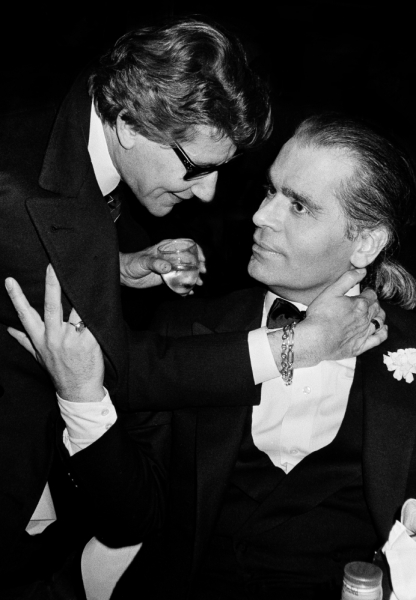 Saint_Laurent_and_Karl_Lagerfeld_—_still_friendly_at_that_point_—_locked_arms_around_each_other_at_Le_Palace_nightclub.jpeg